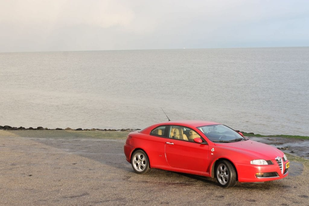 Rode auto, Alfa romeo GT, langs de kade, texel, zee