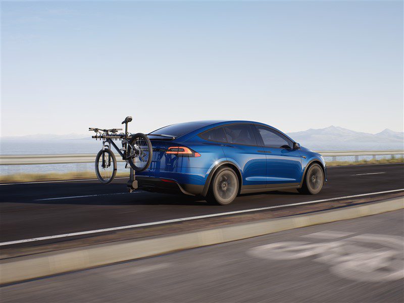 blue Tesla Model X rear driving